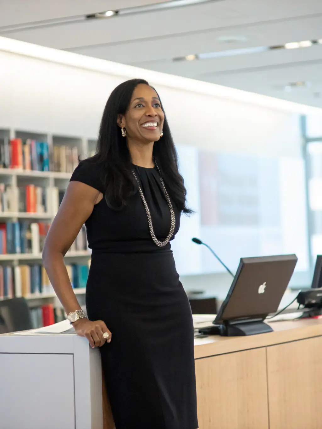 A professional headshot of Dr. Anya Sharma, a keynote speaker at the 2024 London AI Summit, smiling confidently against a blurred background of the conference hall.